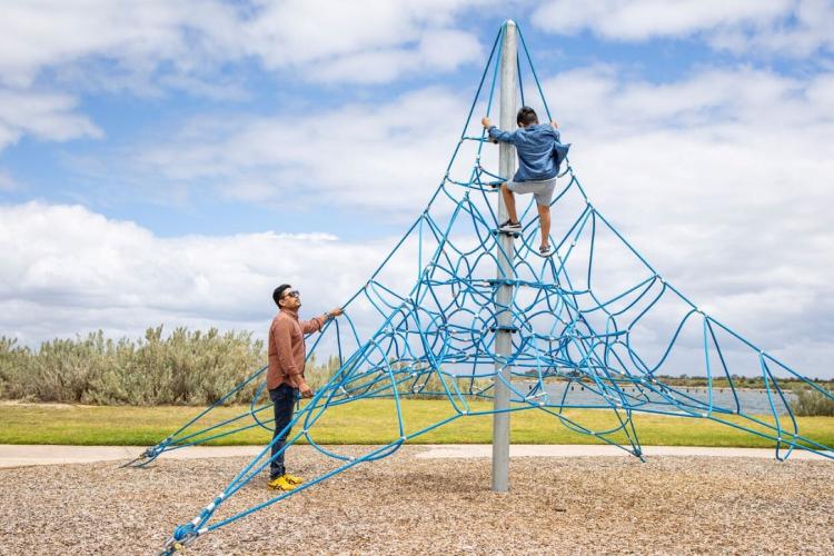 Family playing on playground at Werribee South Foreshore