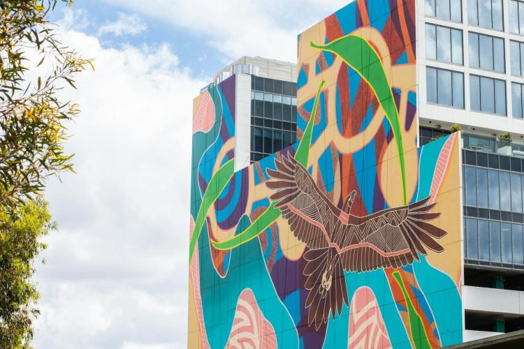 wall mural on tall building featuring a giant eagle